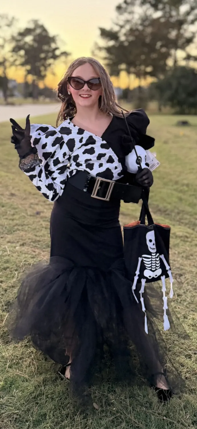 Emma smiling outdoors in costume
